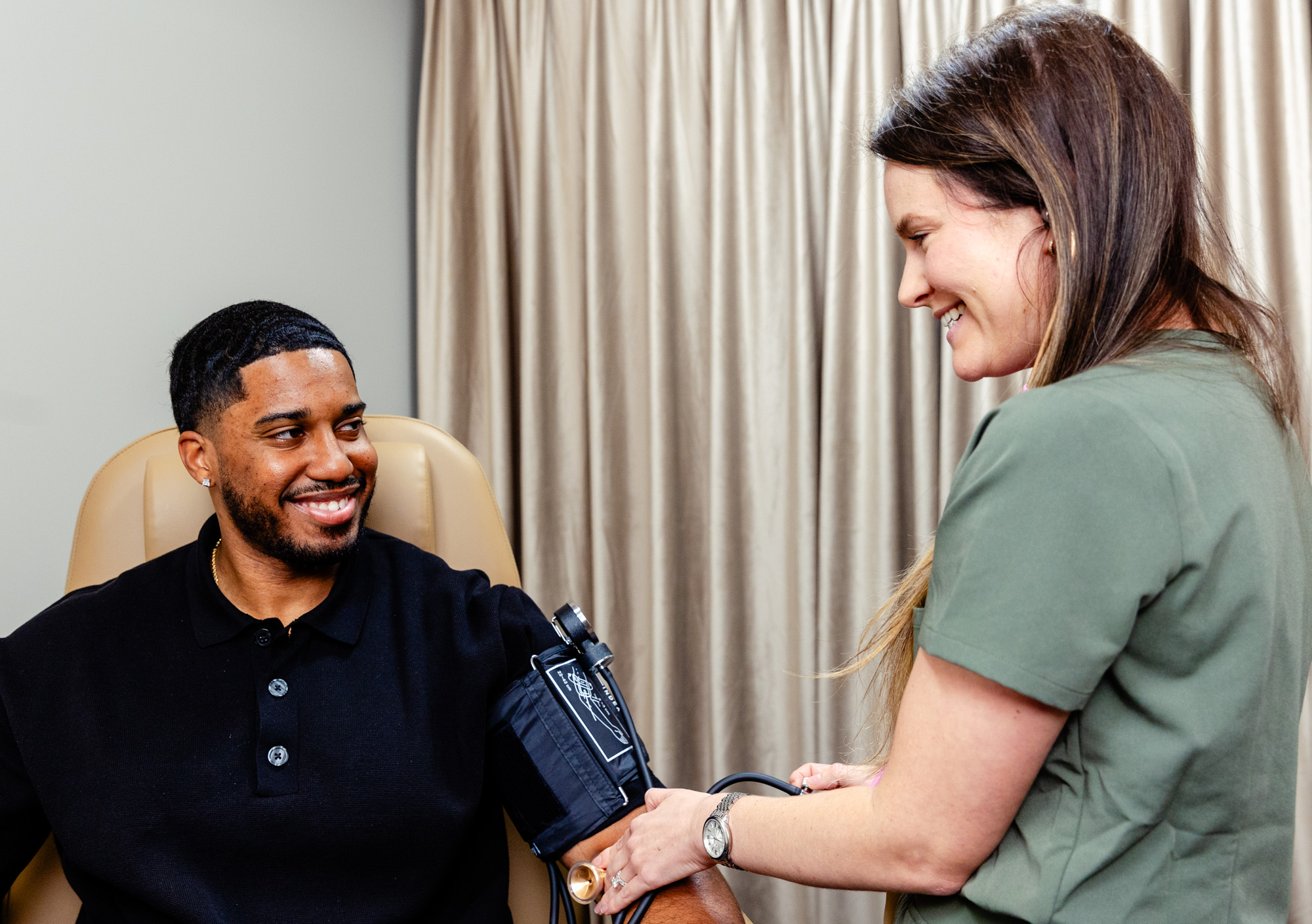Image of Exhibit Medical Aesthetics nurse getting vitals of a patient, preparing them to talk with their provider about hormone replacement therapy in Denville. 