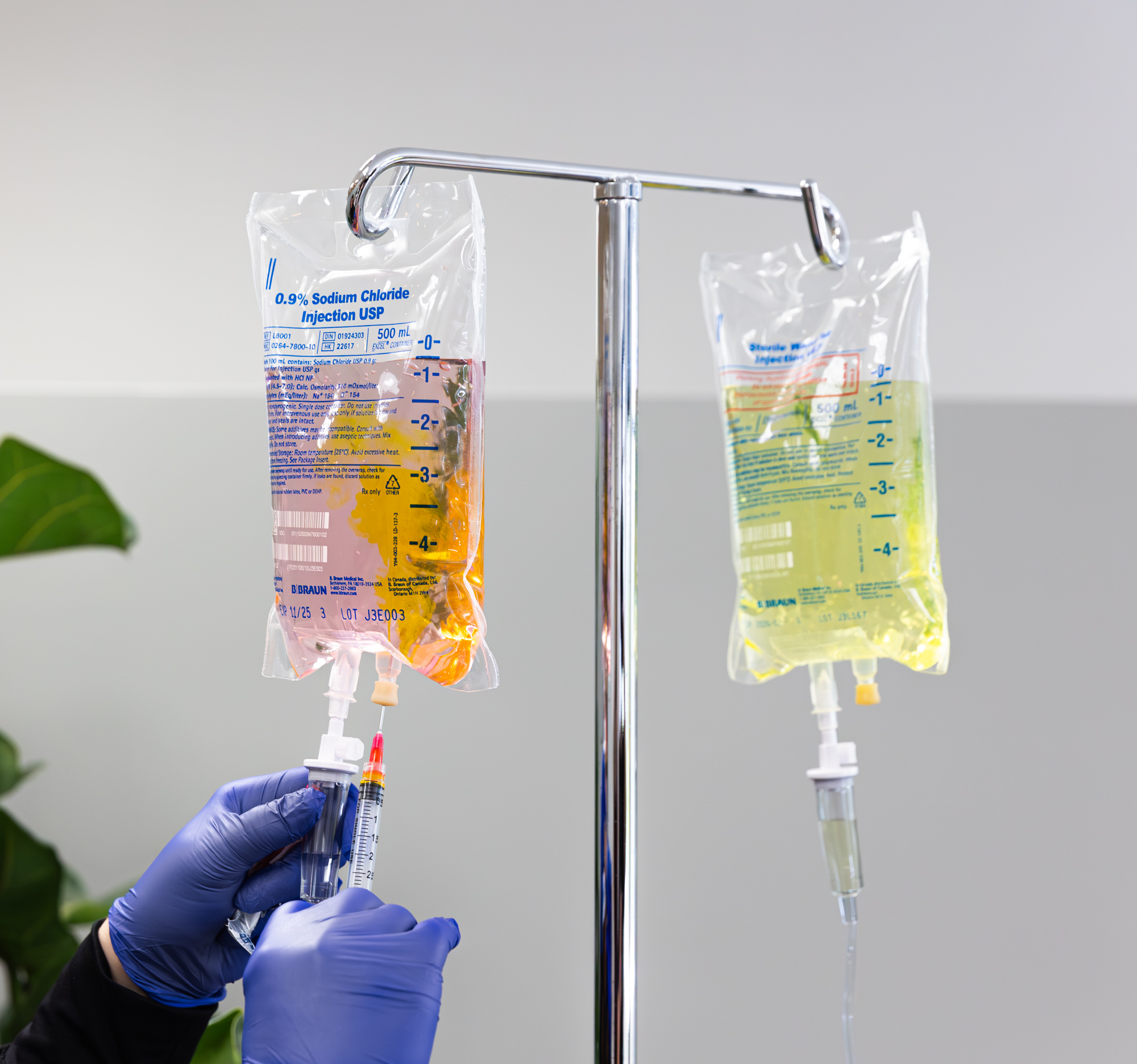 Image of Exhibit Medical Aesthetics provider setting up IV drips bags for IV therapy near Mountain Lakes, NJ.
